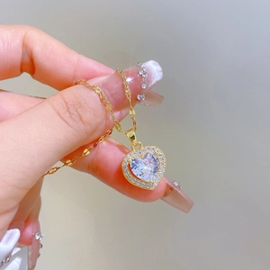 Gold heart pendant necklace with shimmering crystals on an O-chain for women