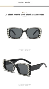 Detail of oversized black square sunglasses with crystal-encrusted frames and grey lenses