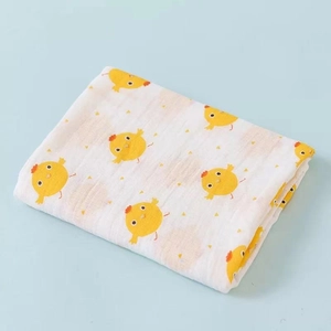 Double-layer cotton gauze baby swaddle blanket with cute yellow chick print on white background