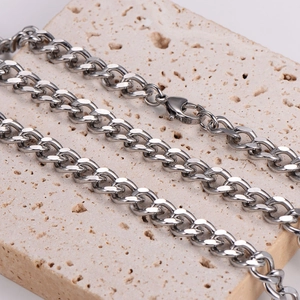 S-shaped 8mm silver cuban link chain for men with lobster clasp on beige stone