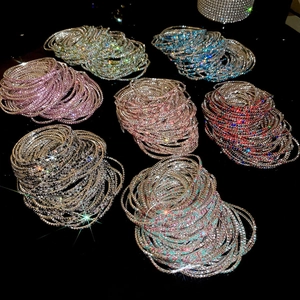Close-up of sparkling colorful crystal rhinestone layered stretch bracelets on black background