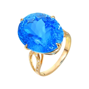 Luxurious oval blue topaz ring with nest cut and gold band featuring side diamonds