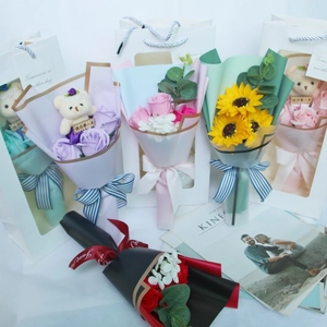 Detail of soap flower bouquets with teddy bears in elegant windowed gift bags