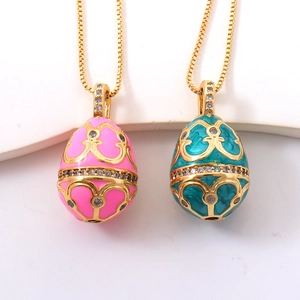 Enamel egg pendants in pink and teal with zircon inlay on vintage gold box chains