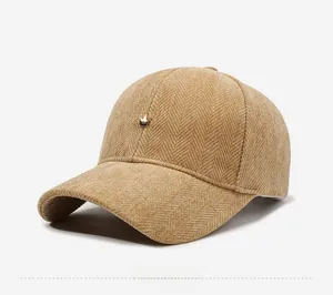 Detailed macro view of camel corduroy baseball cap with golden crown metal emblem