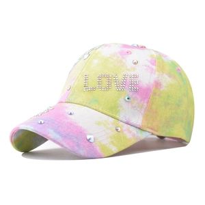 Detailed view of colorful tie-dye baseball cap with sparkling rhinestones and LOVE logo