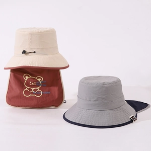 Detail of kids sun hat with neck flap featuring a cute bear pattern and windproof cord