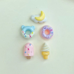 Detailed view of 5-piece resin nail art charms featuring donuts and ice cream shapes