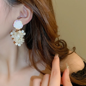 Elegant white acrylic flower drop earrings with golden core details for women