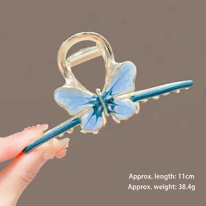 Detail view of a 11cm blue fishtail hair claw clip with gold frame weighing 38.4g