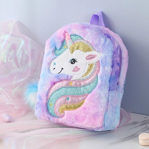 Close-up of unicorn plush backpack featuring glittery horn and macaron gradient fur detail