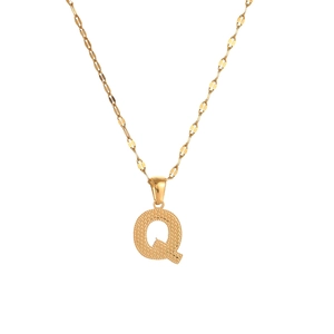Close-up of golden letter Q pendant with textured finish on a thin stainless steel chain