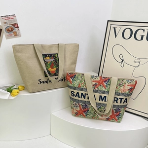 Detailed embroidery of starfish and tropical illustration on beige linen tote bags