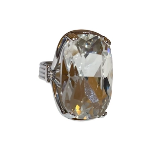 Sparkling silver oval gemstone open ring with four-prong setting on white background