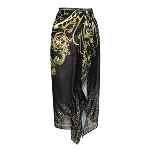 Detail of black and gold baroque print wrap skirt with leopard accents and waist tie