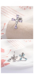 Detailed view of cross stud earrings with purple and blue teardrop zircon stones