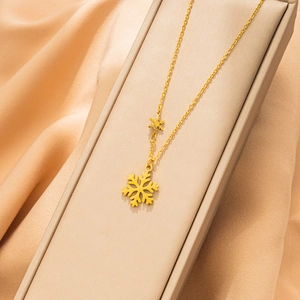 Minimalist 18K gold-plated snowflake pendant necklace presented in a luxury gift box