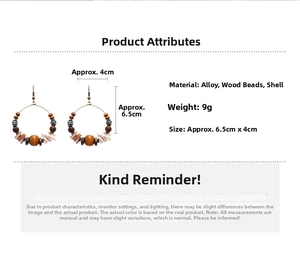 Detailed view of ethnic earrings with wood beads and shell discs on white background