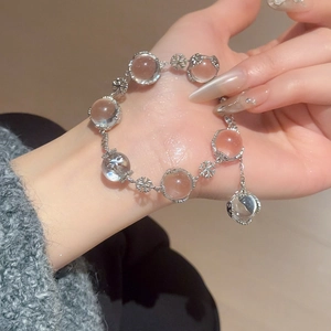 Macro detail of snowflake beaded bracelet with clear crystal beads on a model's wrist