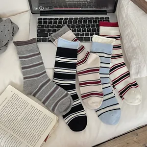 Detail of striped cotton crew socks set featuring ribbed cuffs and colorful patterns