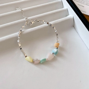 Detailed close-up of macaron color beaded bracelet with silver cubes and lobster clasp