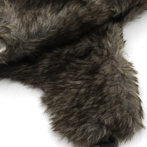 Detailed close-up of thick synthetic fur lining on winter earflap hat with brown texture