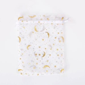 Close-up of white organza pouch with gold and silver moon star patterns and drawstring