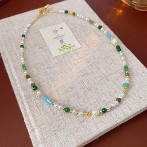 New Chinese style pearl necklace with green beads and gold OT buckle on linen