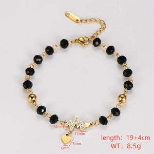 Detail of golden stainless steel beaded bracelet with heart and lightning bolt charms