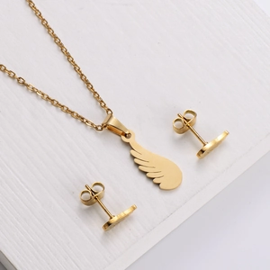 Gold stainless steel wing jewelry set featuring a pendant necklace and matching stud earrings