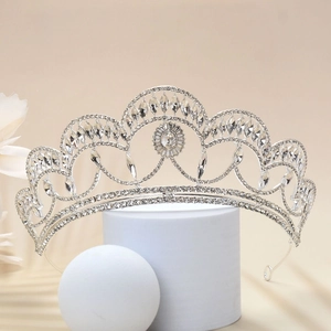 Close-up of a silver vintage bridal crown featuring intricate crystal and rhinestone settings