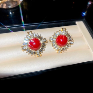 Macro shot of French vintage round red gemstone earrings with sparkling halo setting