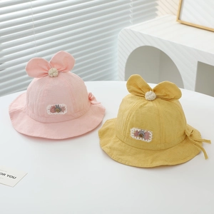 Detailed view of pink and yellow baby sun hats with bunny ears and soft jacquard fabric