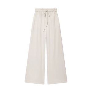 Flat lay of beige wide-leg pants featuring an elastic drawstring waist and fluid drape