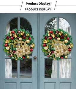 Detailed Christmas wreath with red ornaments and gold flowers on blue wooden doors