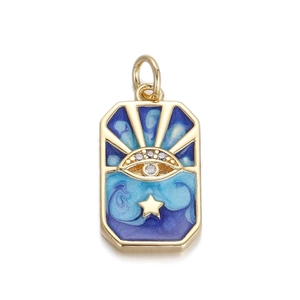Detail showing a golden celestial pendant with blue enamel sun, eye, and star motifs