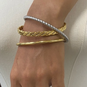 Three-piece set of twisted and smooth 18K gold plated stainless steel bangles for women