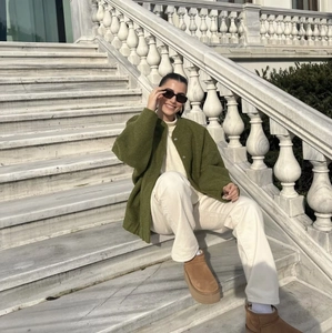 Outdoor street shot of an olive green oversized jacket paired with platform boots
