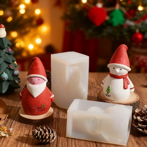 Silicone molds for DIY Santa and Snowman candles with Christmas tree decor background