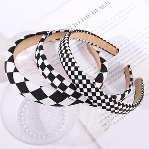 Detail of black and white checkered headbands with non-slip lining on a glass bowl