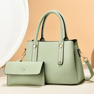 Elegant light green leather tote bag with matching pouch and golden metal hardware