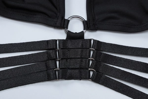 Detail of black V-neck top showing silver metal ring and four elastic straps