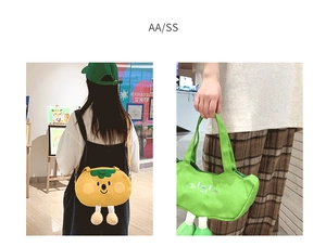 Detail of cute canvas bags featuring cartoon faces and 3D plush legs in yellow and green