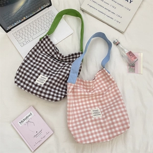 Flat lay of pink and brown checkered canvas tote bags with vibrant shoulder straps