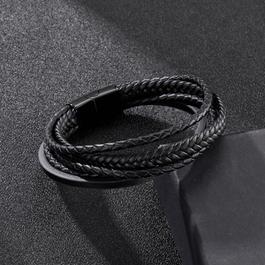 Macro shot of multi-layer braided black leather bracelet with sleek magnetic steel clasp