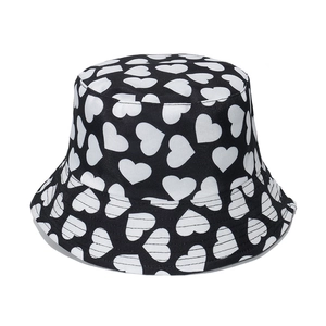 Classic black bucket hat with white heart print for women, casual summer sun protection