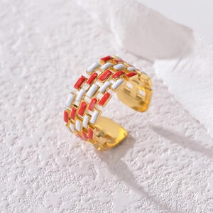 Vintage French hollow gold ring with red and white enamel accents on stone background