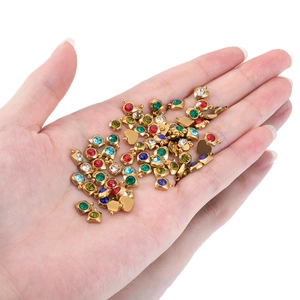 Golden stainless steel heart and square pendants with colorful rhinestones on palm