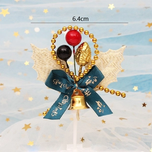 Golden leaf Christmas cake topper with red berries and green ribbon bow decoration