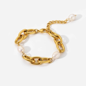 Close-up of vintage gold chunky chain bracelet with three white freshwater pearls